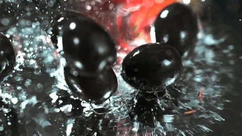 Lot of black olives fall on the table under  in slow motion , 4k, phantom Stock Footage 114978222