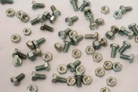 A lot of bolts and nuts on a withe background. Foto stock