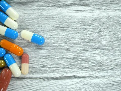 A lot of capsules on a white-gray background with copy space. Stock Photos