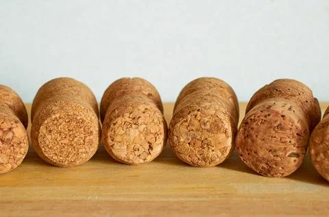 A lot of champagne corks are lying on a wooden table. Close-up. Macro Stock Photos