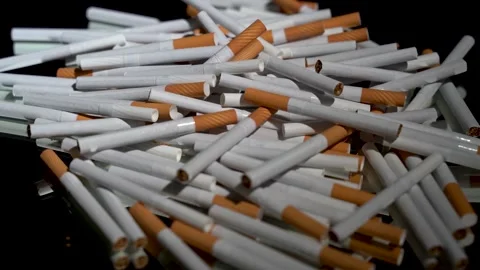 A lot of cigarettes in bulk on a rotating table Stock Footage 256015431