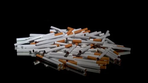 A lot of cigarettes in bulk on a rotating table 動画素材 256015750