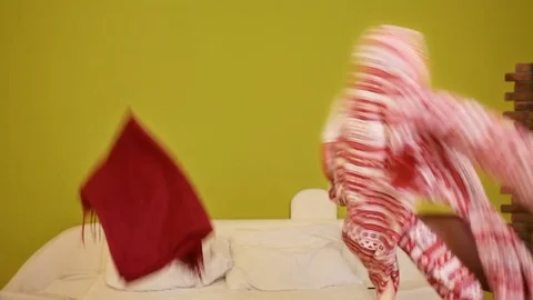 A lot of clothes flying up in air, throwed up by by funny girls which sort their Stock-Footage 77264005