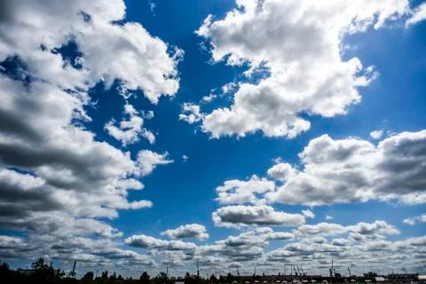 A lot of clouds in the blue sky on a summer sunny day. Stock Photos
