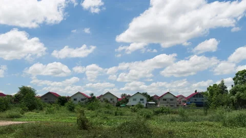 Lot of clouds passing over six houses timelapse. Stock Footage 156381719