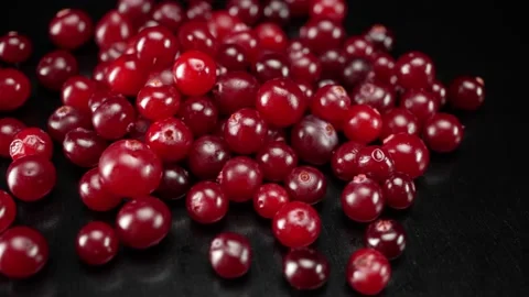 A lot of cranberries close up on a black background Stock Footage 148498966