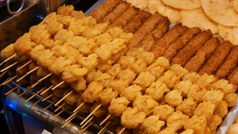 A lot of deep fried meat balls and satay on sticks. Asian street food. BBQ Stock-Footage 113043901