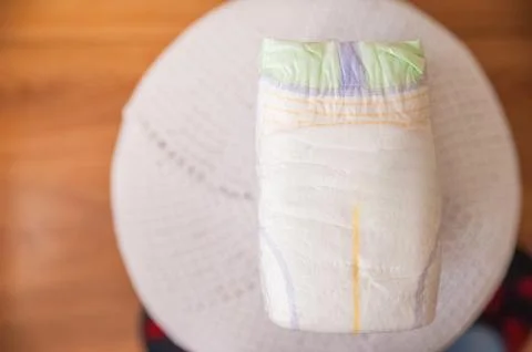 A lot of diapers in a stack close-up and copy space. Newborn, diapers, ecology. Stock Photos