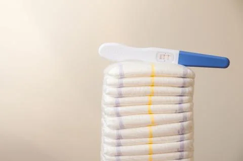 A lot of diapers in a stack close-up and copy space. Diapers and a positive preg Stock Photos