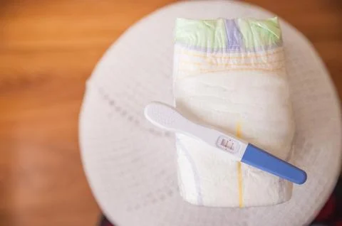 A lot of diapers in a stack close-up and copy space. Diapers and a positive preg Stock Photos