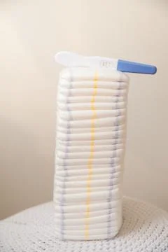 A lot of diapers in a stack close-up and copy space. Diapers and a positive preg Stock Photos