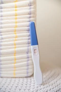 A lot of diapers in a stack close-up and copy space. Diapers and a positive preg Stock Photos