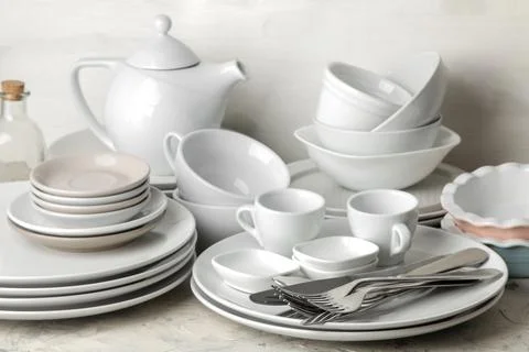 A lot of different dishes. Dinnerware. on a light concrete background. dishes Stock Photos
