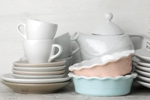 A lot of different dishes. Dinnerware. on a light concrete background. dishes Stock Photos