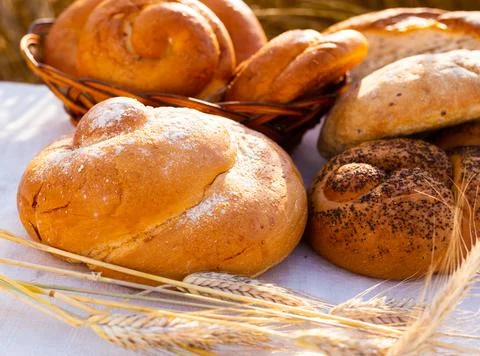 Lot of different flavored bread, wheat, rye, on the table in the field outside Foto stock