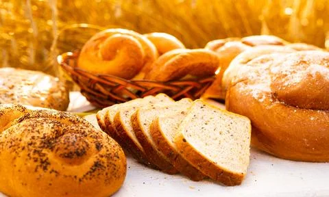 Lot of different flavored bread, wheat, rye, on the table in the field outside Stock Photos