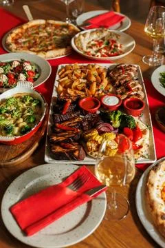 A lot of different food on the Banquet table.A large number of prepared dishes Stock Photos
