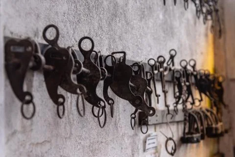 A lot of different metallic bits hanging on a wall Stock Photos