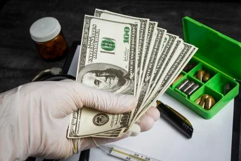 A lot of dollars in the doctor's hand Foto stock