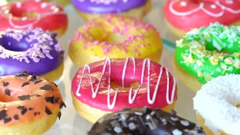 A lot of donuts laid out in rows. Freshly made and oily doughnuts are amazing an Stock Footage 199489333