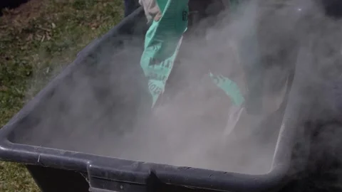 A lot of dust appears when placing dry cement in a bucket Stock Footage 151699597