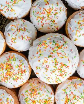 A lot of Easter cakes with sugar icing and colored ornaments. Stock Photos