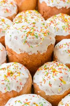 A lot of Easter cakes with sugar icing and colored ornaments. Stock Photos