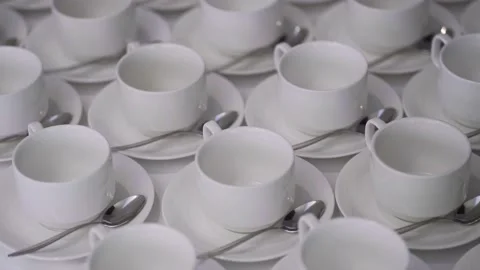 A lot of empty white cups or mugs plates are on the table. The concept of hot Stock Footage 146518969