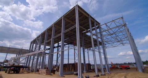 A lot of equipment is working on the construction of a new, modern factory Stock Footage 161985658