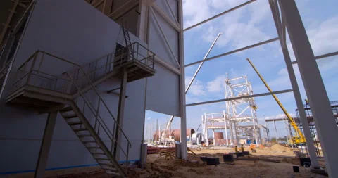 A lot of equipment is working on the construction of a new, modern factory Stock Footage 161985718