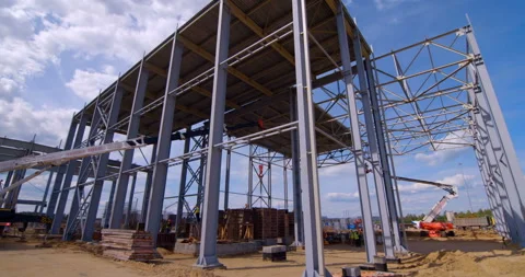 A lot of equipment is working on the construction of a new, modern factory Stock Footage 161986128