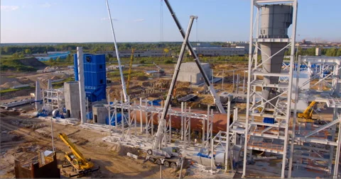 A lot of equipment is working on the construction of a new, modern factory Stock Footage 161992096