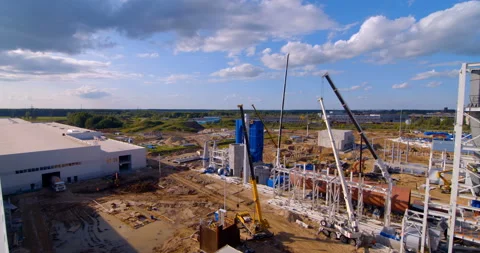 A lot of equipment is working on the construction of a new, modern factory Stock Footage 161992116