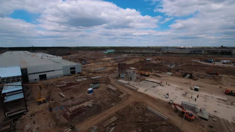 A lot of equipment is working on the construction of a new, modern factory Stock Footage 162002144