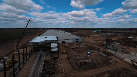 A lot of equipment is working on the construction of a new, modern factory Stock Footage 162002171