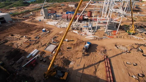 A lot of equipment is working on the construction of a new, modern factory Stock Footage 162002392