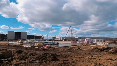 A lot of equipment is working on the construction of a new, modern factory Stock Footage 162002408