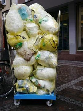 Lot of filled bin liner street Foto stock