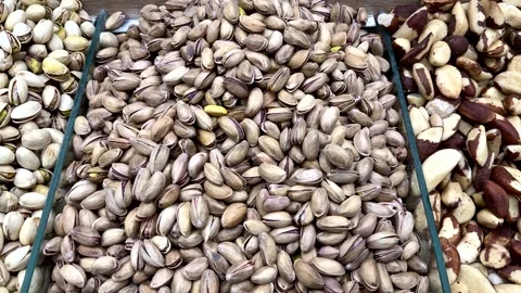 A lot of fried selected clean delicious pistachios for sale in a box at a local Stock Footage 316432257