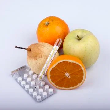 Lot of fruits, pills and thermometer on white Stock Photos