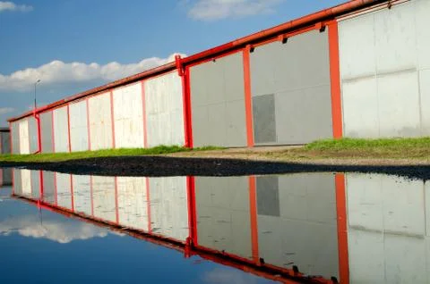 A lot of garages, puddle with reflection. Stock Photos
