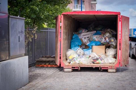 A lot of garbage is transported in a large container Stock Photos