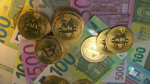 Lot of gold physical Bitcoin crypto currency coins on stacks euro bills Vídeo Stock 266985689
