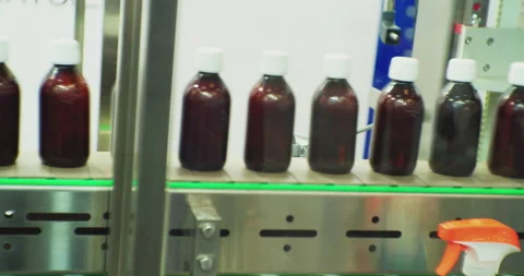 A lot of identical plastic bottles move quickly along the conveyor.close-up Stock Footage 207744260