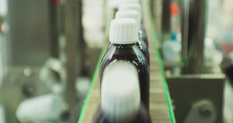 A lot of identical plastic bottles move quickly along the conveyor. Stock Footage 218615001