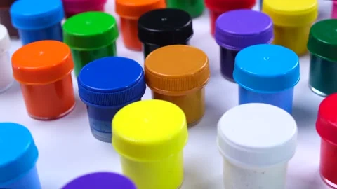 A lot of jars with multi-colored paints on a white background, the concept of Stock Footage 211997935