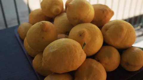 A lot of lemons lie on the black table Stock-Footage 133007466
