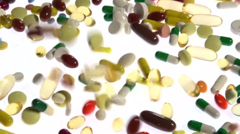 A lot of multicolored tablets and capsules fall, filling the entire screen. Stock-Footage 55339595