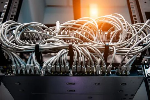 A lot of network cables connected in a big network switch. Stock Photos