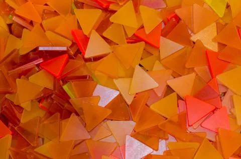 A lot of orange plastic triangles background. Orange and yellow triangles. Stock Photos